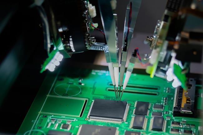 Close up of a machine quality testing a printed circuit board