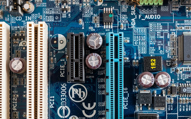 Close up photo of a blue printed circuit board.