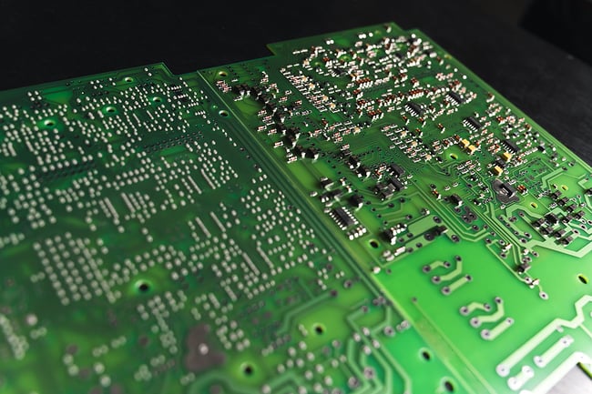 Close up photo of a printed circuit board sitting on a black table